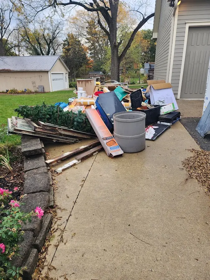 Dumpster being loaded with debris for Commercial Dumpster Rental in Clovis